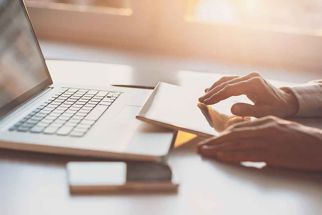 Person's hands working on a computer